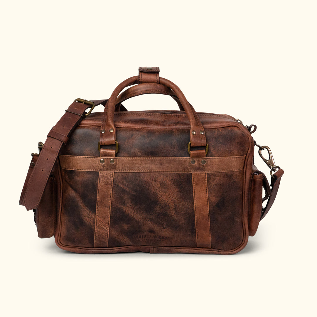 Men's rugged dark oak leather pilot bag showcasing a detailed rear view with multiple secure pockets, adjustable shoulder strap, and robust handles. Ideal for versatile use.